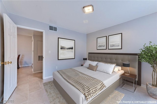 bedroom featuring light tile patterned flooring, visible vents, and baseboards