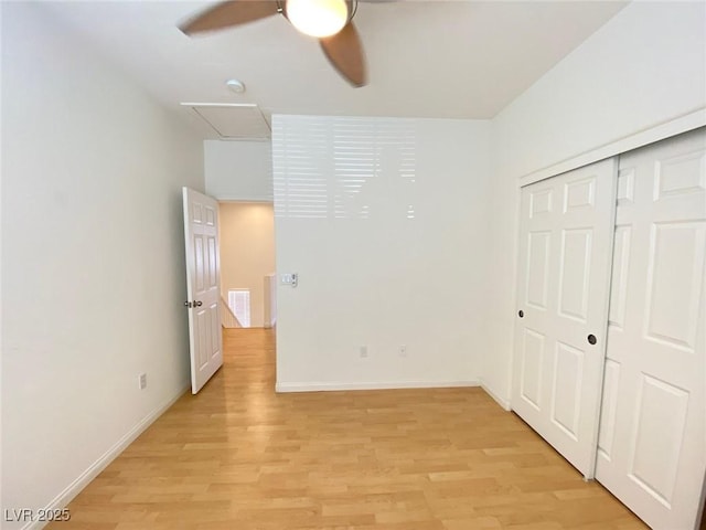 unfurnished bedroom featuring light wood-style floors, a closet, visible vents, and baseboards