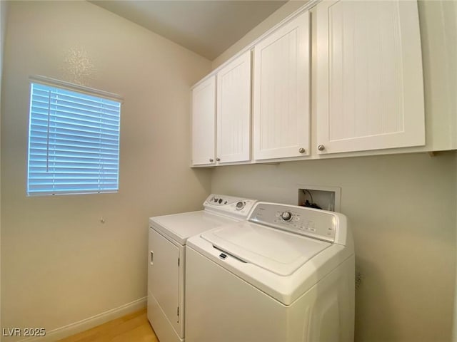 washroom with independent washer and dryer, cabinet space, and baseboards