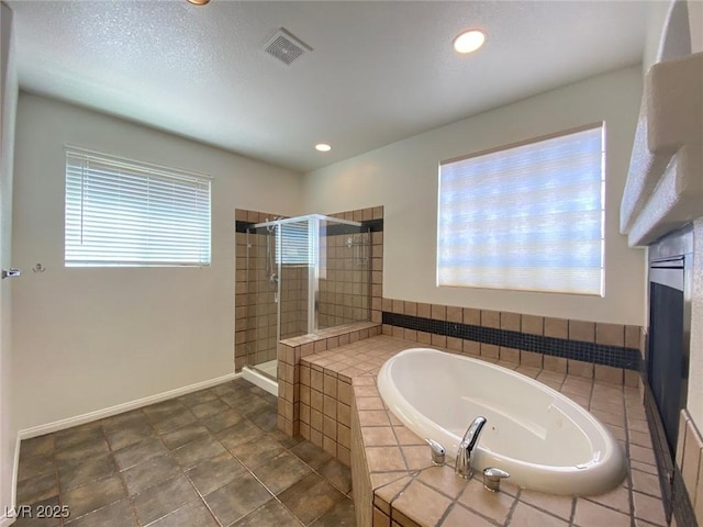 bathroom featuring a stall shower, baseboards, visible vents, a bath, and recessed lighting