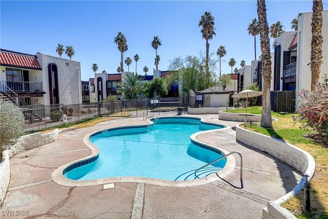 pool featuring a patio and fence