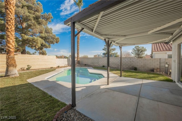 view of swimming pool featuring a patio, a yard, and a fenced backyard