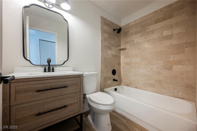 full bath with toilet, shower / tub combination, wood finished floors, and vanity