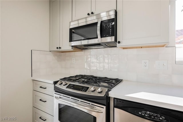 kitchen with appliances with stainless steel finishes, light countertops, and backsplash