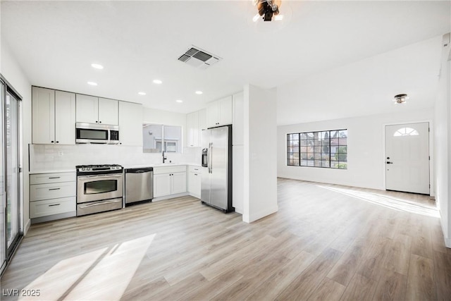 kitchen featuring appliances with stainless steel finishes, light countertops, visible vents, and light wood finished floors