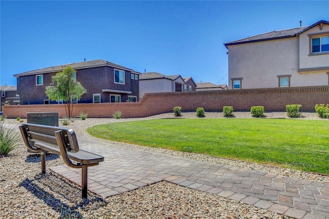 view of yard with a patio, fence, and a residential view