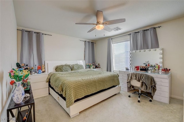 bedroom with a ceiling fan, visible vents, and light colored carpet