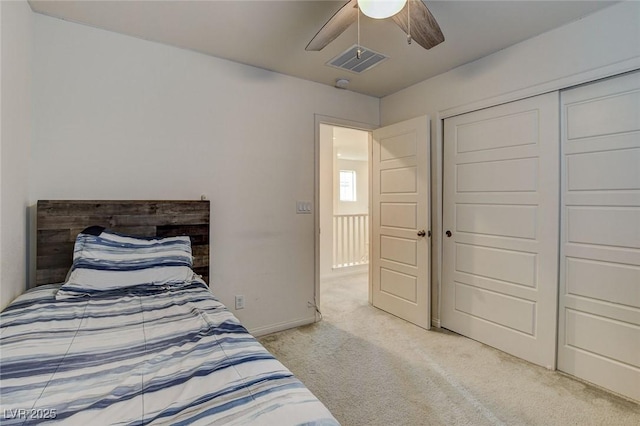 bedroom featuring ceiling fan, baseboards, visible vents, and light colored carpet