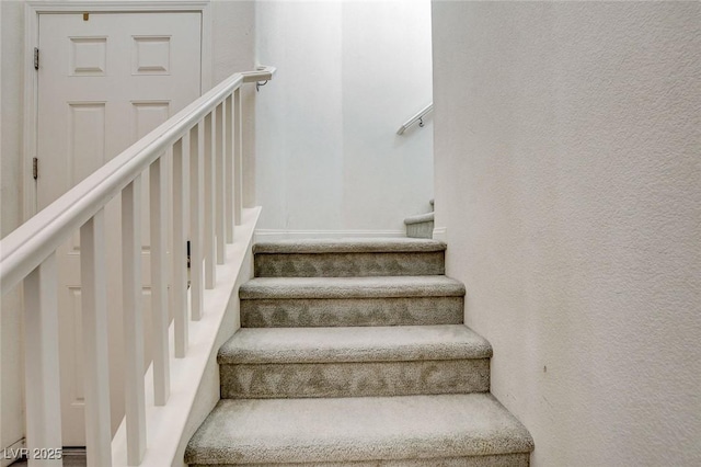 stairway with a textured wall