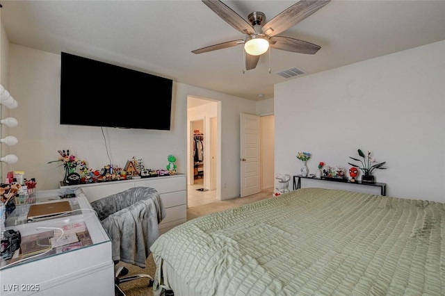 bedroom featuring visible vents, ceiling fan, and a spacious closet