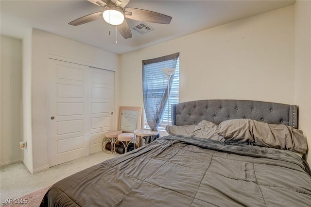 carpeted bedroom with a ceiling fan, baseboards, visible vents, and a closet