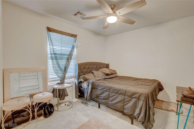 carpeted bedroom featuring visible vents and ceiling fan