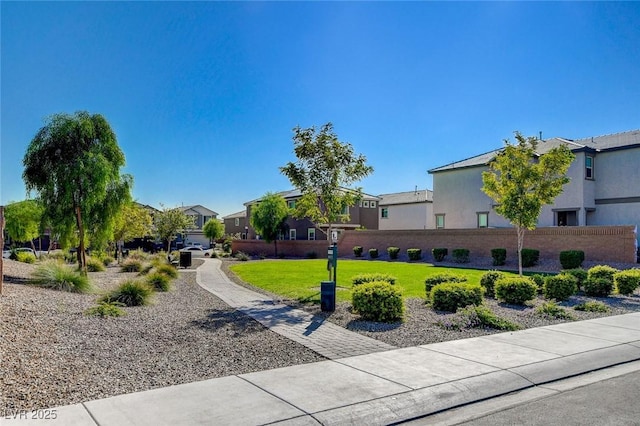 view of property's community featuring a residential view and a yard