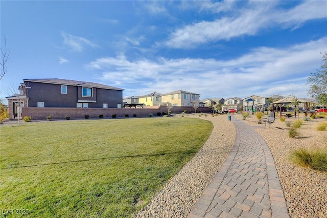 view of community featuring a yard and a residential view