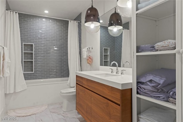 full bathroom featuring toilet, marble finish floor, shower / bath combination with curtain, and vanity