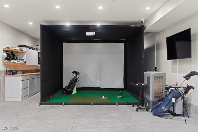 rec room featuring golf simulator, recessed lighting, and finished concrete flooring