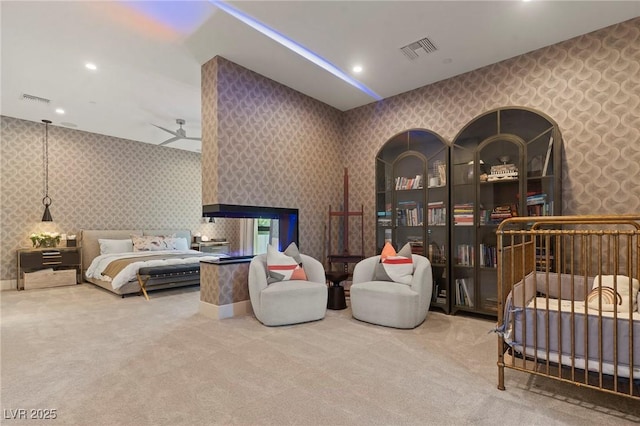 bedroom featuring carpet, visible vents, and wallpapered walls