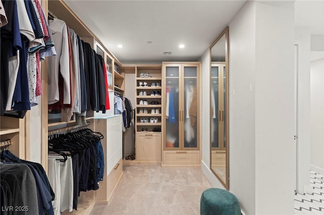 spacious closet with light carpet and visible vents