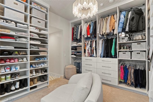 spacious closet featuring carpet flooring and a notable chandelier