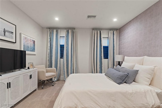 bedroom with light carpet, visible vents, and recessed lighting