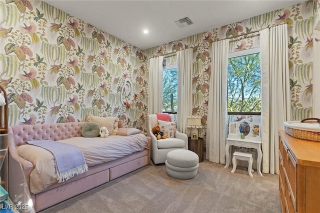 carpeted bedroom with visible vents and wallpapered walls