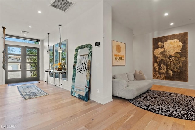 foyer entrance featuring recessed lighting, visible vents, baseboards, and wood finished floors