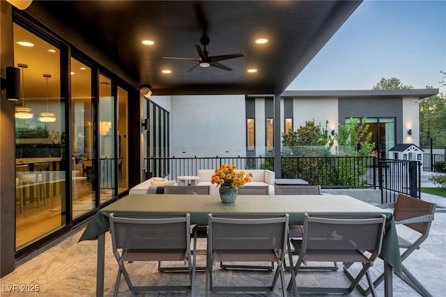 balcony with outdoor dining space, a patio area, and ceiling fan