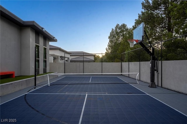 view of basketball court with a tennis court, community basketball court, and fence