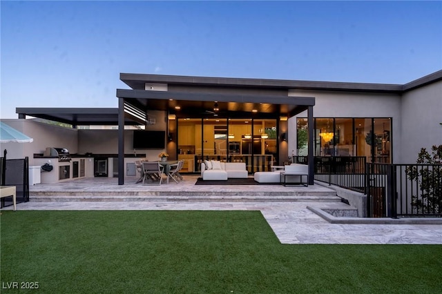 rear view of property featuring a patio area, a yard, outdoor lounge area, and area for grilling