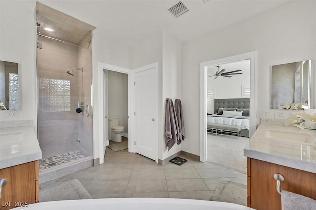 ensuite bathroom featuring toilet, visible vents, vanity, tile patterned floors, and a stall shower