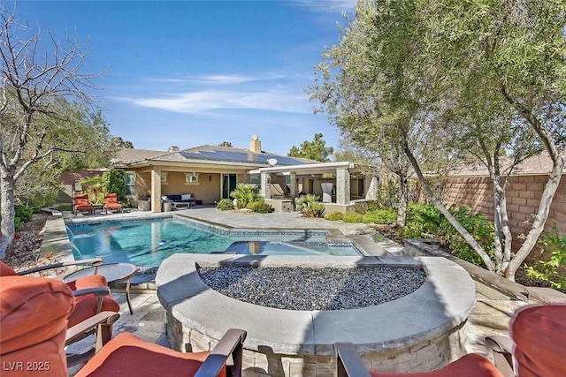 outdoor pool with a patio area and a fenced backyard