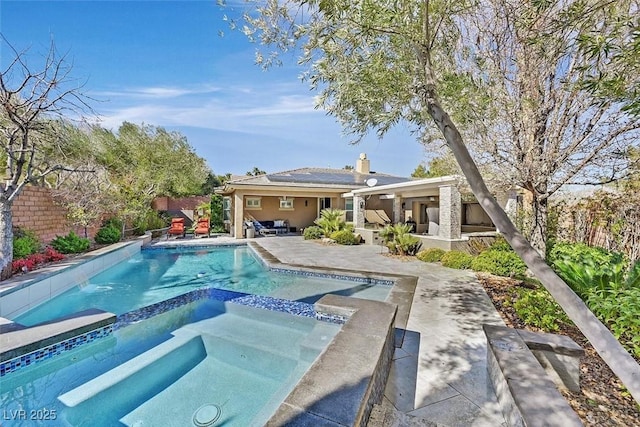 view of swimming pool with a patio area, a fenced backyard, and a pool with connected hot tub