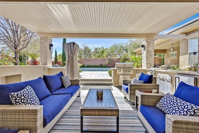 view of patio / terrace featuring a grill, an outdoor living space, an outdoor kitchen, and fence