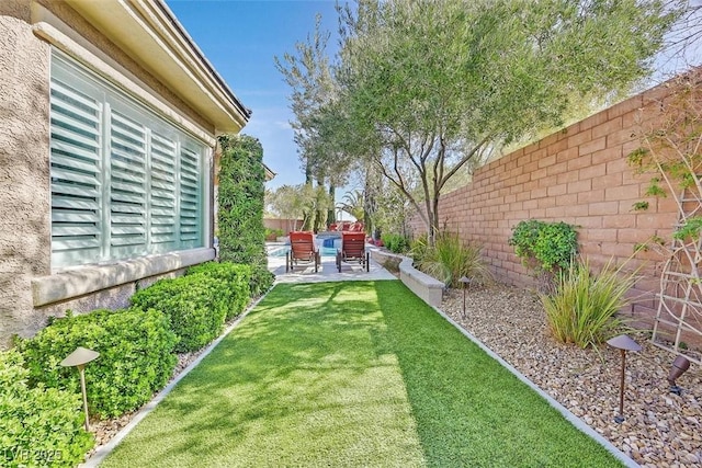 view of yard with a patio area and a fenced backyard