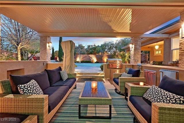 view of patio featuring outdoor lounge area, an outdoor kitchen, and grilling area