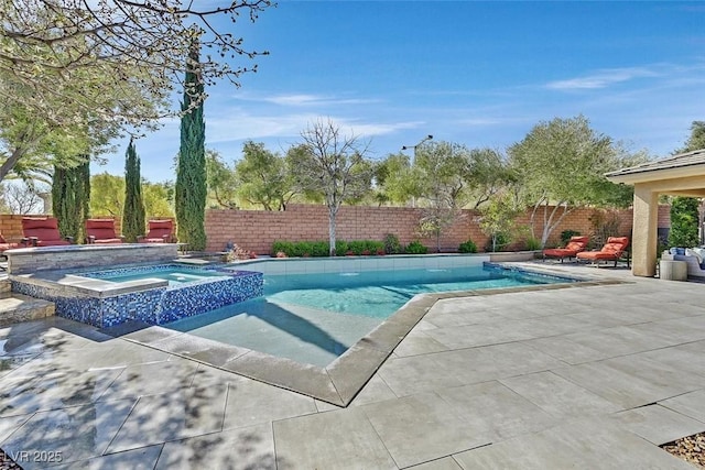 view of pool featuring a patio area, a fenced backyard, and a pool with connected hot tub