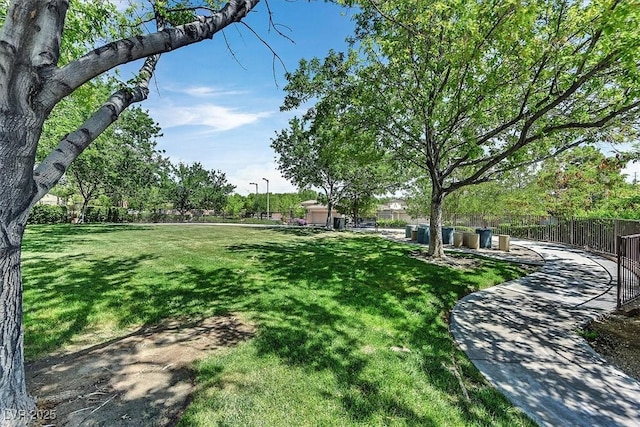 surrounding community with a lawn and fence