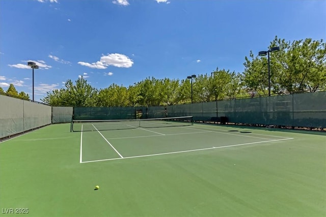 view of sport court featuring fence