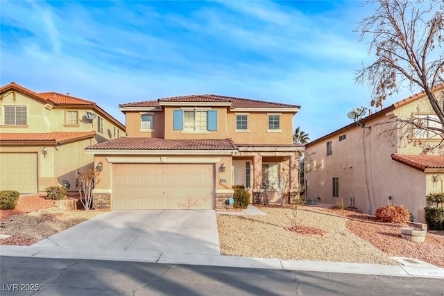 mediterranean / spanish-style home featuring a garage, driveway, a tiled roof, and stucco siding