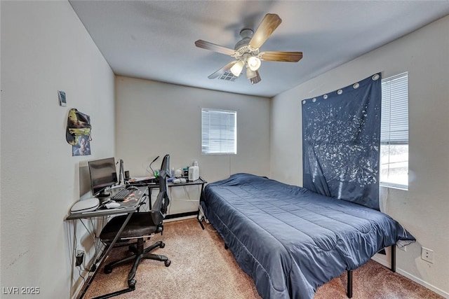 carpeted bedroom with ceiling fan, multiple windows, and visible vents