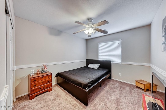 bedroom with ceiling fan, carpet flooring, and baseboards