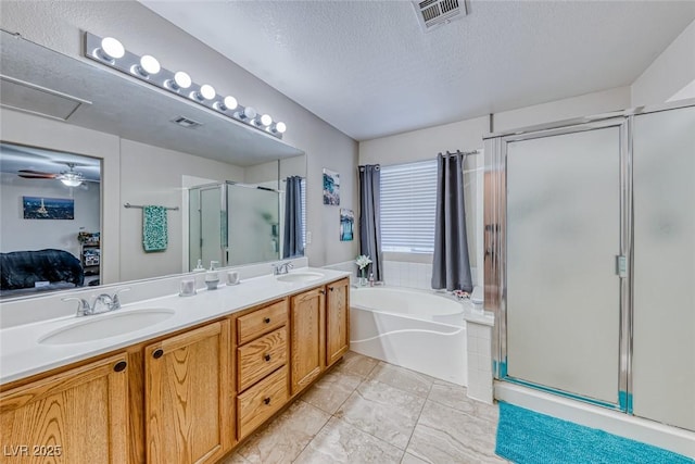 full bath with a stall shower, visible vents, a sink, and a textured ceiling