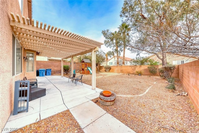 view of patio with a playground, a fenced backyard, and a pergola