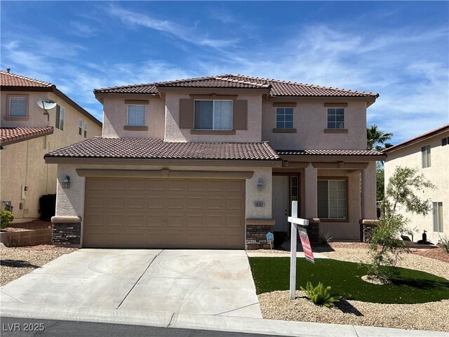 10332 George Hart Ct, Las Vegas, NV 89129 - mediterranean / spanish home with a tile roof, concrete driveway, stucco siding, and stone siding