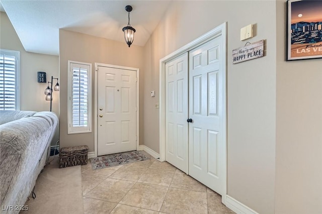 entrance foyer featuring a wealth of natural light, light tile patterned flooring, and baseboards