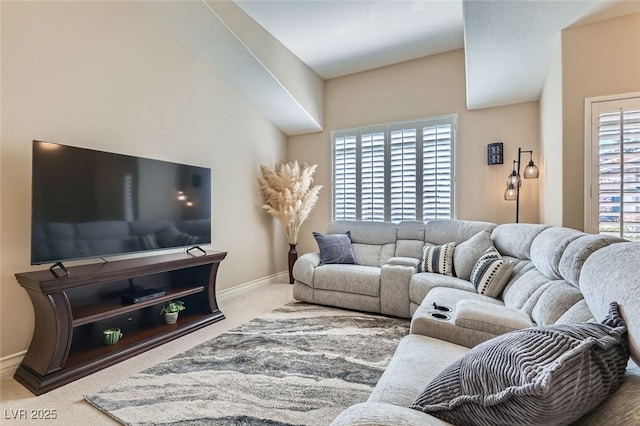 carpeted living room with baseboards