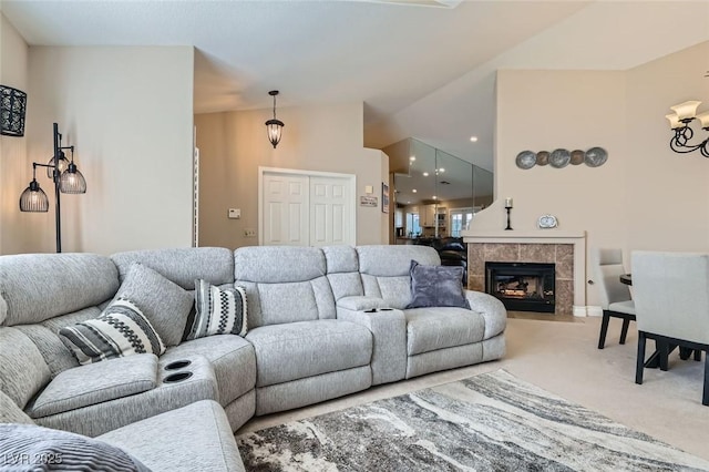 carpeted living area featuring vaulted ceiling and a tiled fireplace