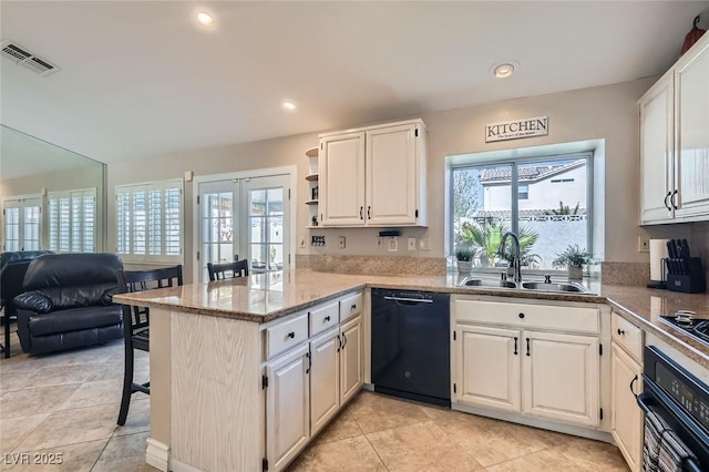 kitchen with french doors, visible vents, a sink, a peninsula, and black appliances