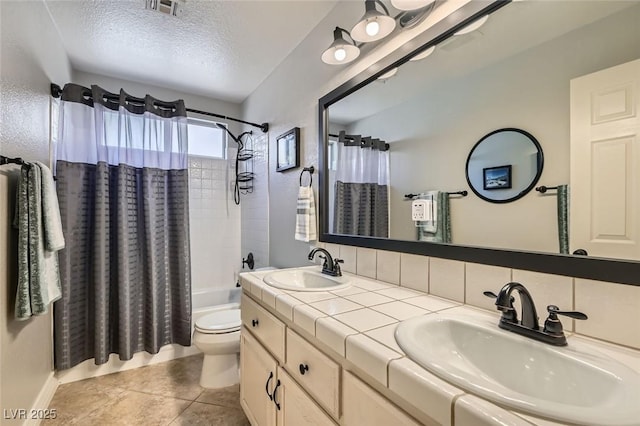 full bathroom featuring toilet, a textured ceiling, visible vents, and a sink