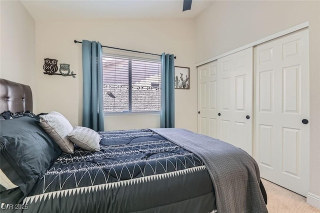 carpeted bedroom featuring lofted ceiling and a closet